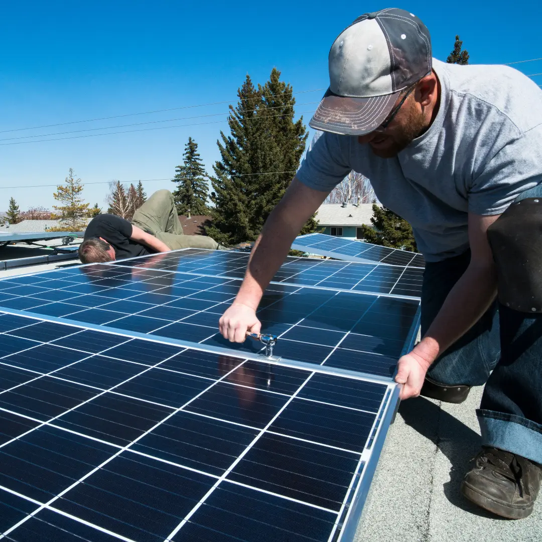 Technician inspecting solar panels for damages